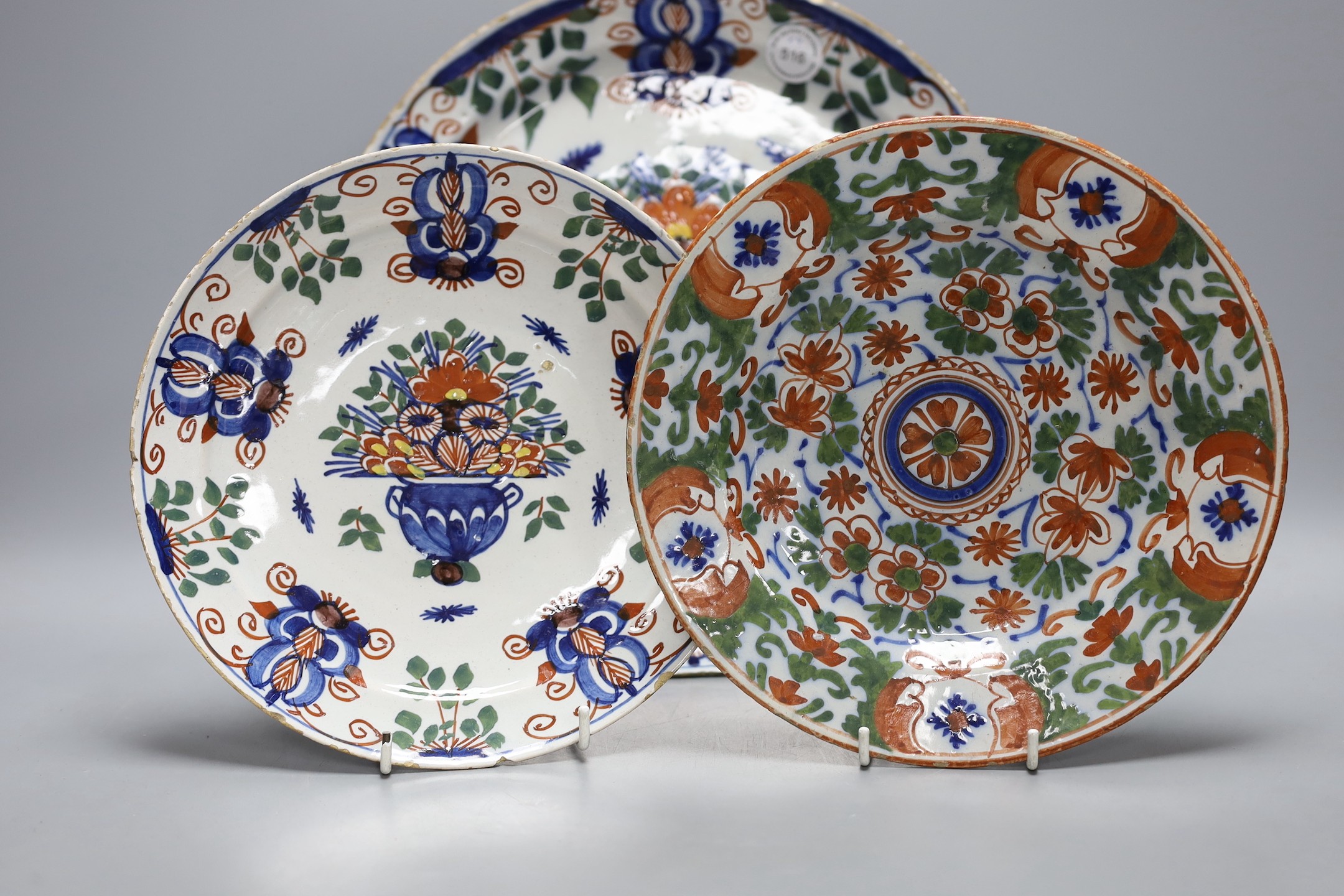 Four 18th century Dutch delft dishes, largest 30.5cm